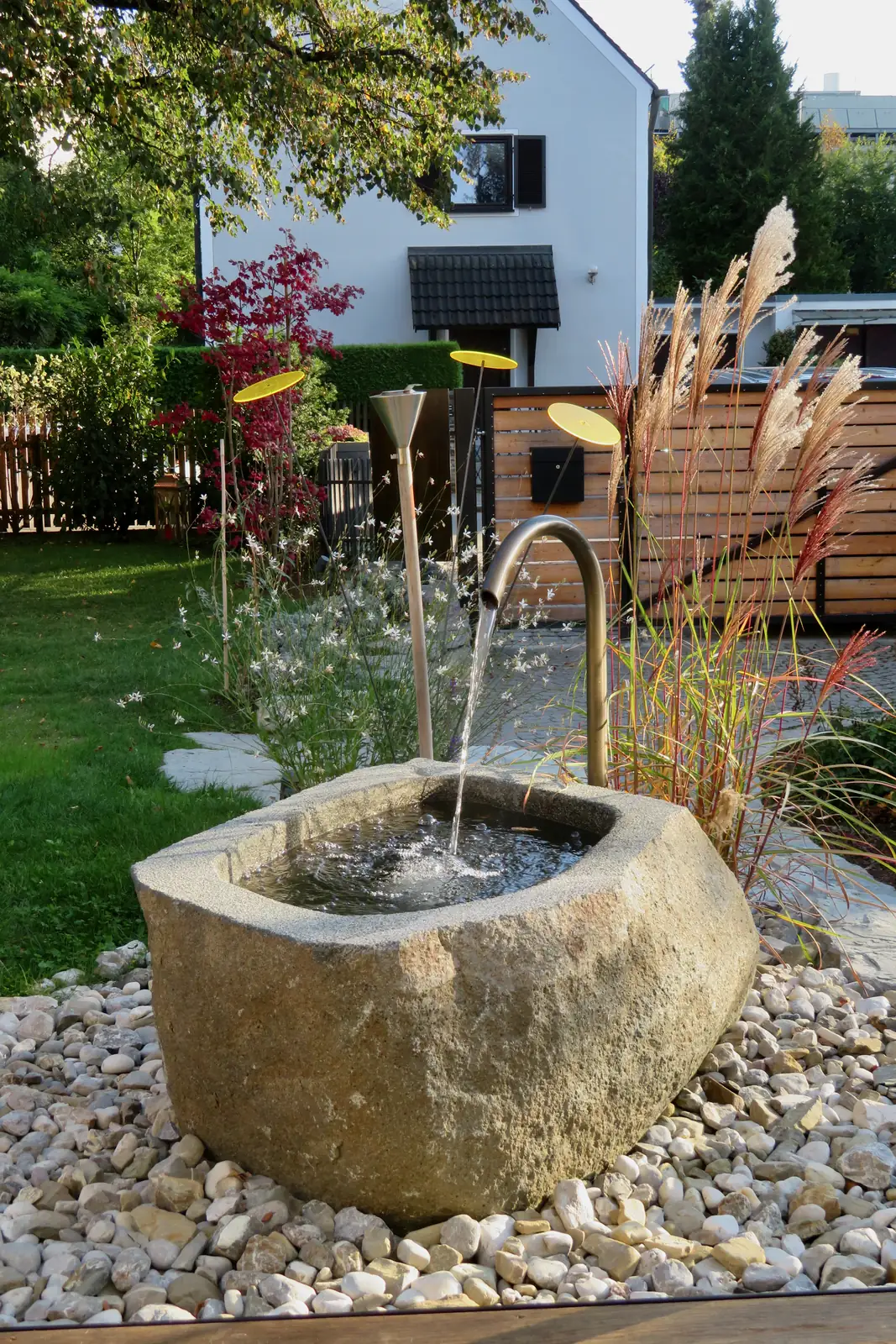 Keine geraden Linien – ein Familiengarten mit Findlingsbrunnen