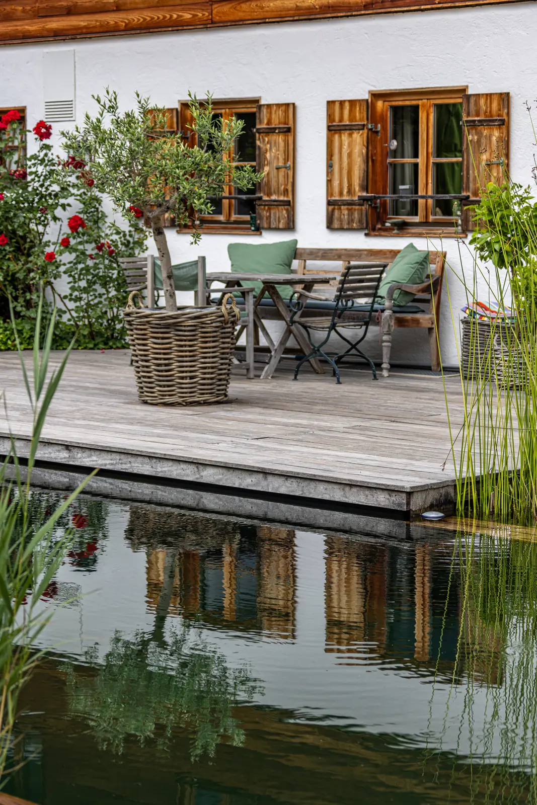 Die möblierte Terrasse am Haus, im Wasser gespiegelt
